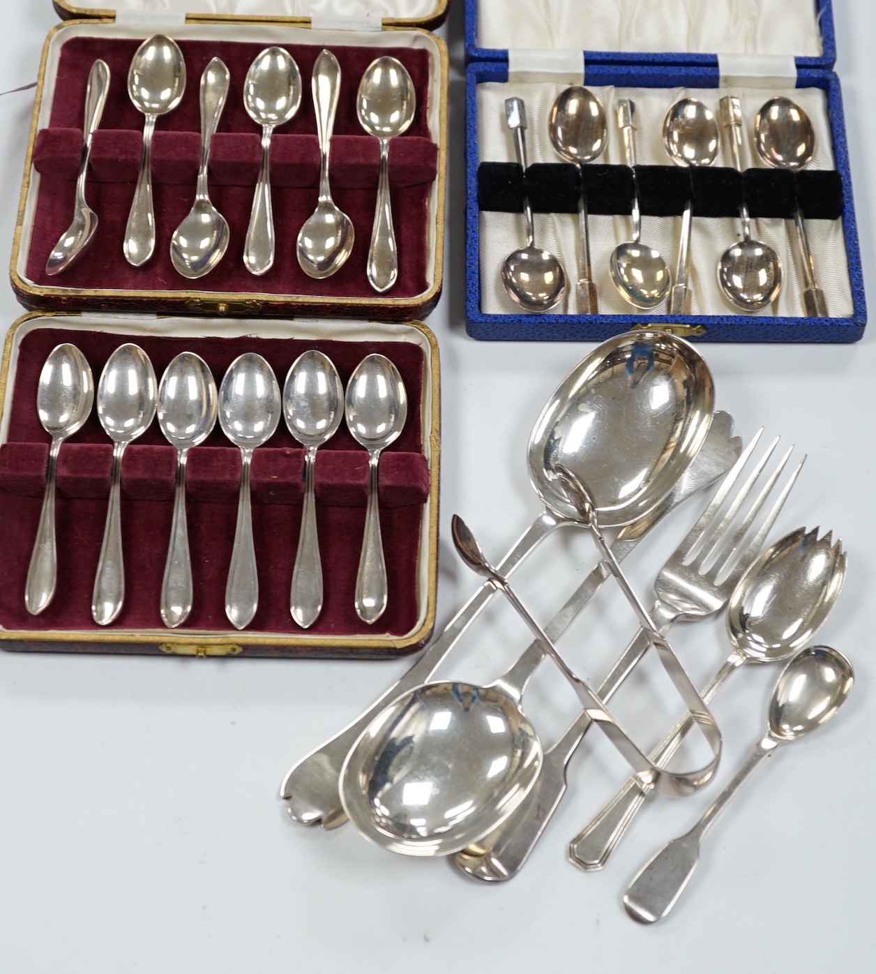 A pair of George V silver rat tail trefid spoons, Goldsmiths & Silversmiths Co Ltd, London, 1911, 20.2cm, three cased sets of silver coffee spoons and other silver flatware